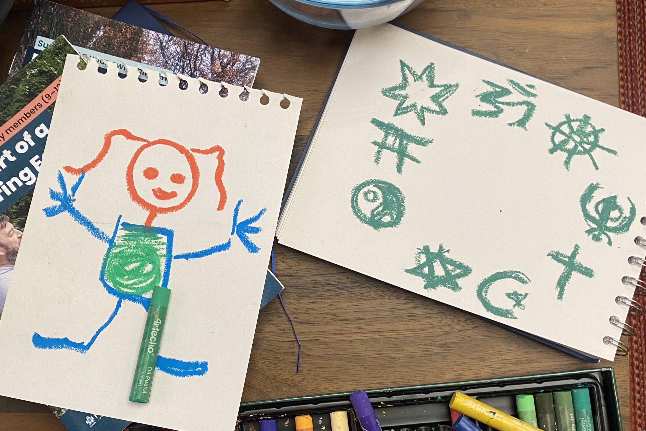 a drawing of a stylised little girl and one showing different faith symbols